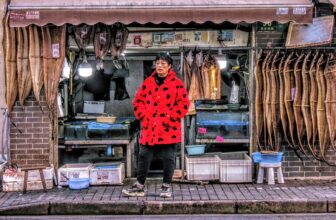 Woman Fishmonger in front of Her Shop
