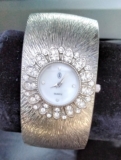 JL women’s silver-tone crystal-encrusted quartz bangle cuff watch.