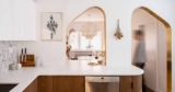Brass-Lined Arches Connect The Kitchen With The Dining Room Inside This Home