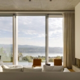 “Water mirror” reflects light into villa overlooking Lake Zurich by PPAA